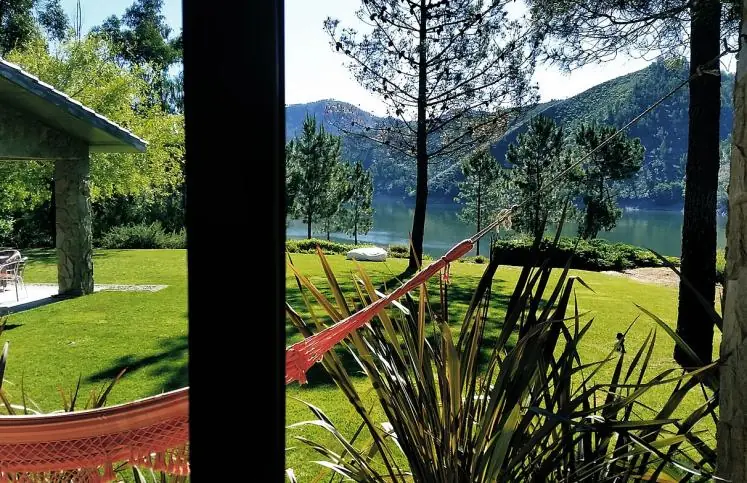 A hammock in the garden overlooking the lake
